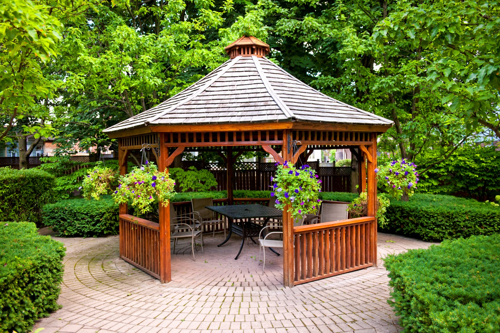 Gazebo in landscaped garden with interlocking stone patio