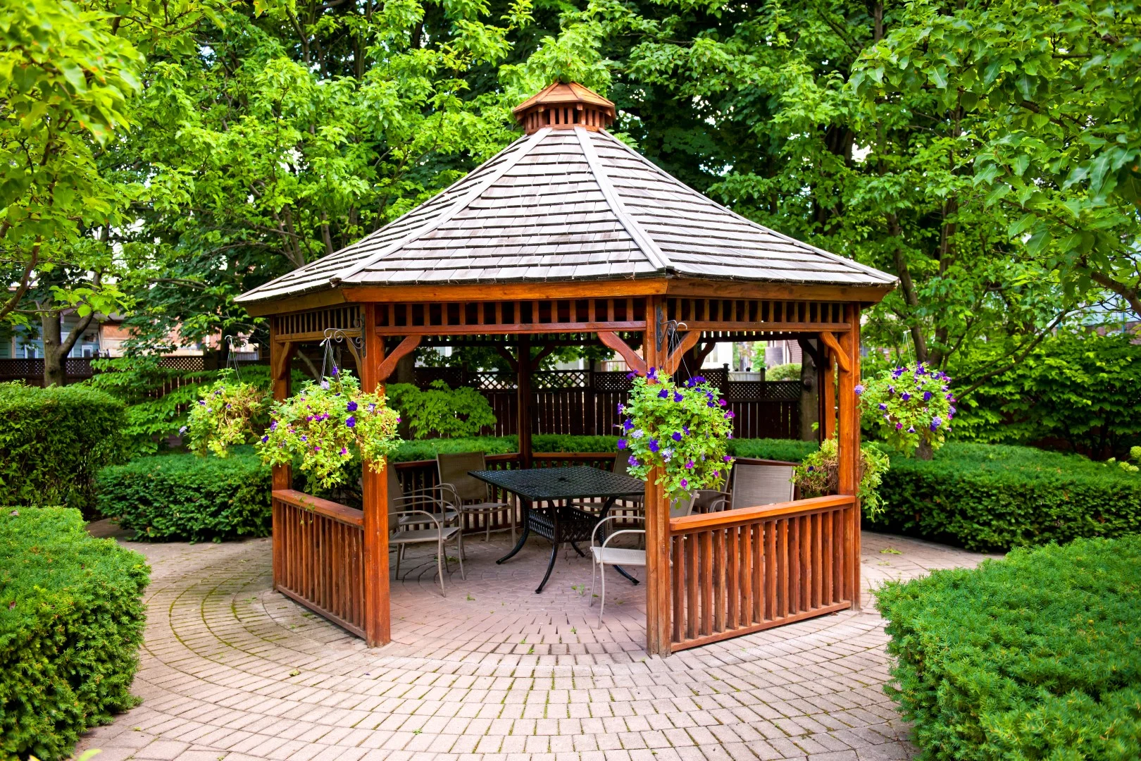 Gazebo in landscaped garden with interlocking stone patio